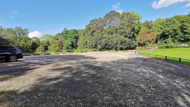 Pay & Display car park at Millhouses Park, surrounded by trees and green space under a clear blue sky.