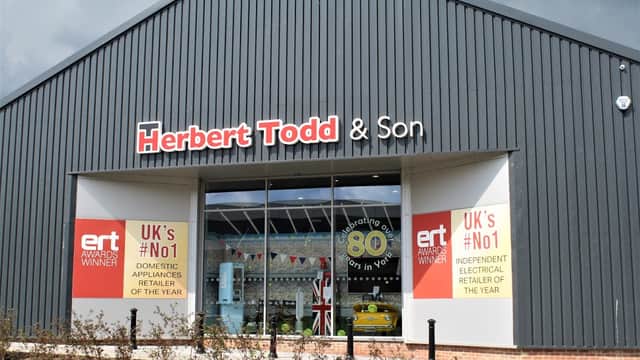 Herbert Todd & Son storefront featuring banners for awards, celebrating 80 years, and showcasing home appliances.