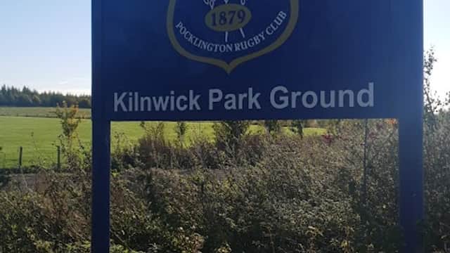 Sign for Kilnwick Park Ground with rugby club emblem, surrounded by greenery and open fields in Yorkshire.