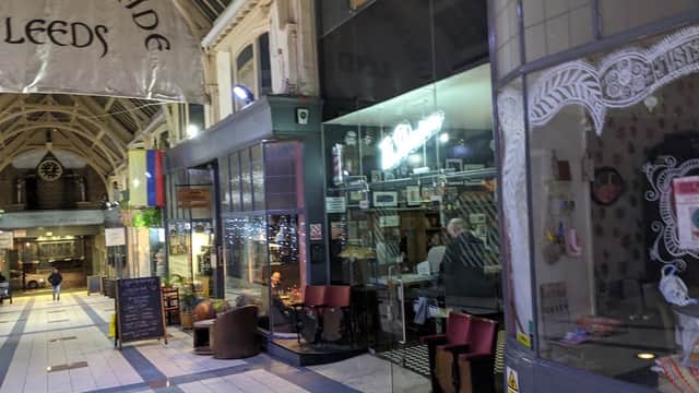 Grand Arcade in Leeds featuring shops, cafes, and decorative architecture with a bustling atmosphere.