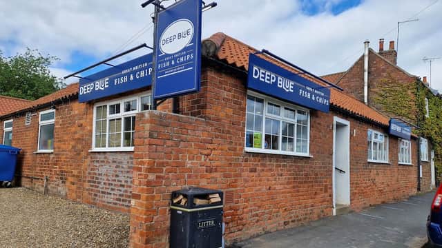 Deep Blue Fish & Chips restaurant with brick exterior, blue signage, and a litter bin outside, set in Brandesburton, Yorkshire.