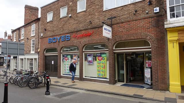 Department store "Boyes" with colorful window displays and bicycles parked outside on a street in York.