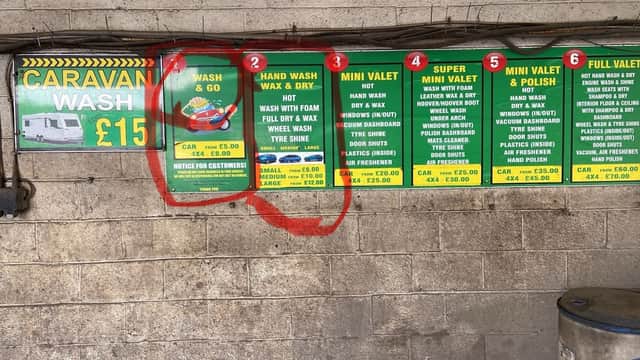 Signboard displaying car wash services and prices, including options for hand wash, mini valet, and full valet.