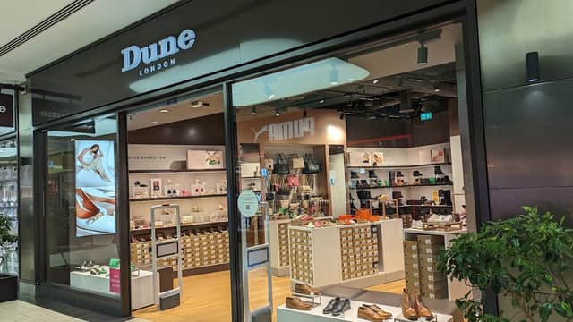 Dune York Outlet storefront showcasing a variety of shoes and accessories, with a modern display and bright lighting.