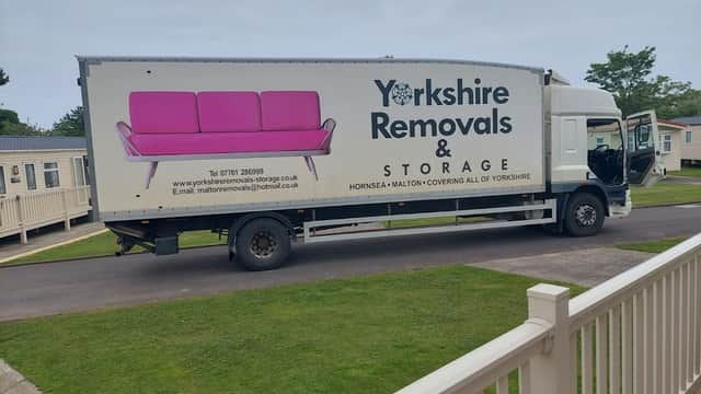 Yorkshire Removals & Storage truck parked, featuring a pink sofa graphic and contact details on the side.