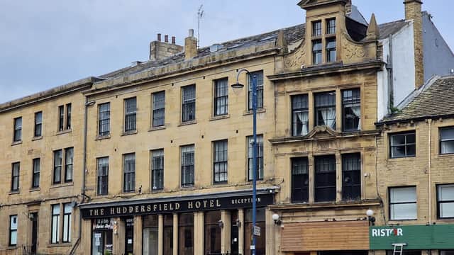 Huddersfield Hotel with a classic facade, large windows, and a sign for reception, set in a historic area.
