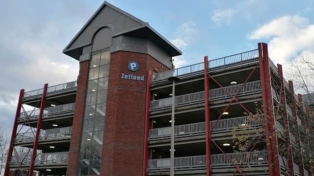 Zetland Multi Storey Car Park with red steel framework, multiple levels, and a clear blue sky in Middlesbrough.