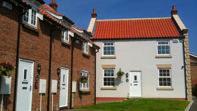 Charming Bed & Breakfast with red-tiled roofs, white and brick facades, and green lawns in Seamer, Scarborough.