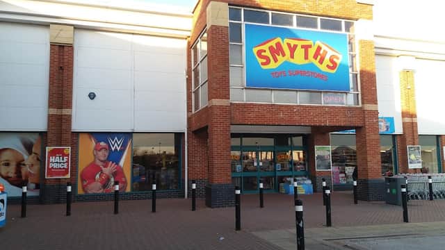 Smyths Toys Superstores entrance with colorful signage, promotional WWE poster, and open storefront in Eckington, Yorkshire.