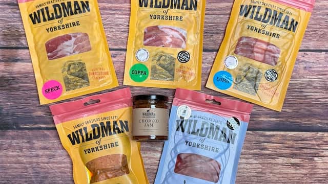 Five colorful packages of cured meats labeled "Wildman of Yorkshire," featuring speck, coppa, lomo, and chorizo.