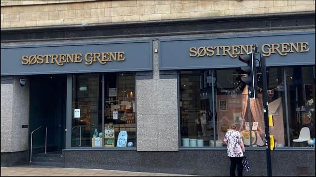 Two large storefronts of Sรธstrene Grene with elegant signage, showcasing home decor and furniture items.