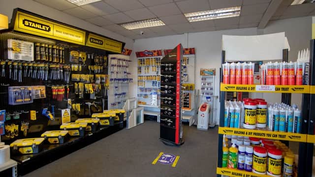 Brightly lit store interior showcasing tools and supplies, featuring Stanley products and various cleaning solutions.