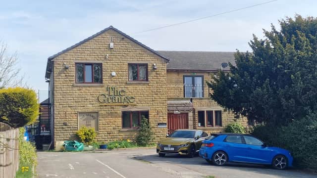 The Grange bar features a stone exterior, green shrubs, and parked blue cars in a sunny Yorkshire setting.