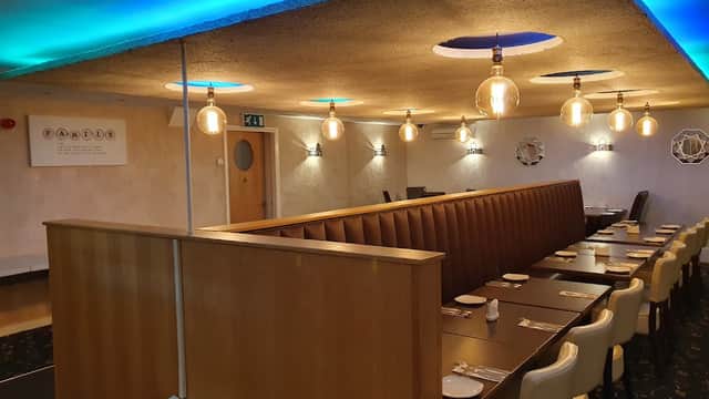 Modern takeaway interior with wooden seating, pendant lights, and blue ambient lighting in Beadlam, Yorkshire.