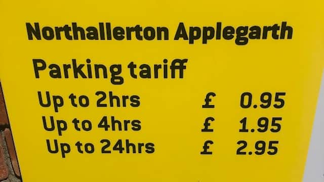 Bright yellow parking sign listing tariffs for Northallerton Applegarth: £0.95 for up to 2hrs, £1.95 for 4hrs, £2.95 for 24hrs.