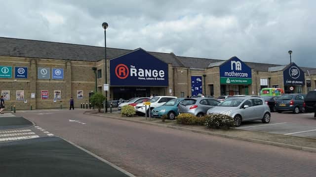 Great Northern Retail Park features shops including The Range and Mothercare, with a parking area and cloudy sky.