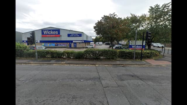 Pay & Display parking area near Wickes store in Thornhill, Yorkshire, with cars and trees lining the street.