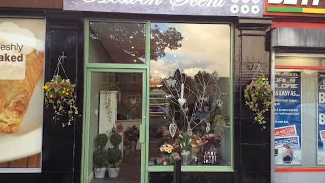 Heaven Scent Florist storefront with green door, floral displays, and hanging baskets in Apperley Bridge, Yorkshire.
