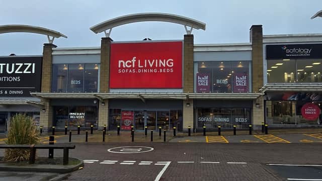 Junction27 shopping center in Birstall, featuring Natuzzi and ncf Living storefronts with promotional signage.