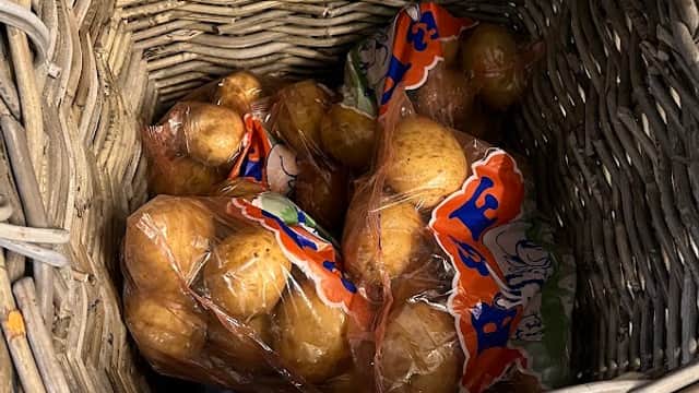 A wicker basket containing several bags of oranges at Bempton Post Office.