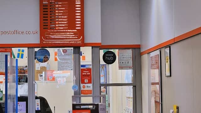 Interior of Thirsk Post Office featuring a service counter, notice boards, and a bureau de change display.