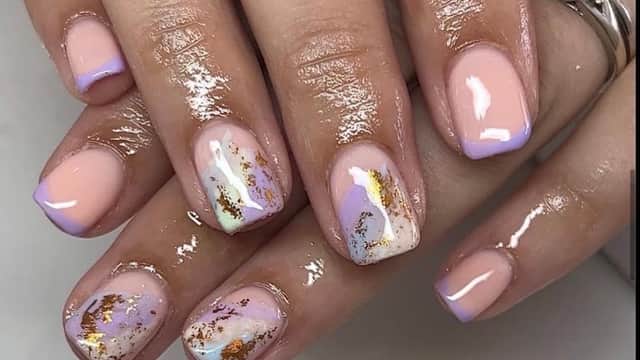 Elegant manicured nails featuring pastel colors, gold accents, and artistic designs.
