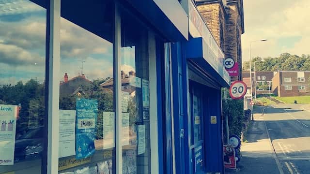 Turners Newsagents storefront with blue signage, displays of newspapers, and a "Play here!" sign outside.