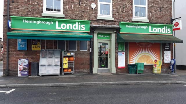 Hemingbrough Londis storefront with green signage, ice cream display, and orange sun mural on the wall.
