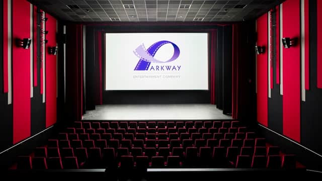 Interior of Parkway Cinema Beverley featuring red and black decor, a large screen, and rows of empty red seats.