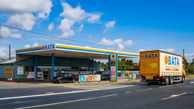 BATA petrol station with convenience store, featuring a truck and cars, set against a blue sky in Gate Helmsley.