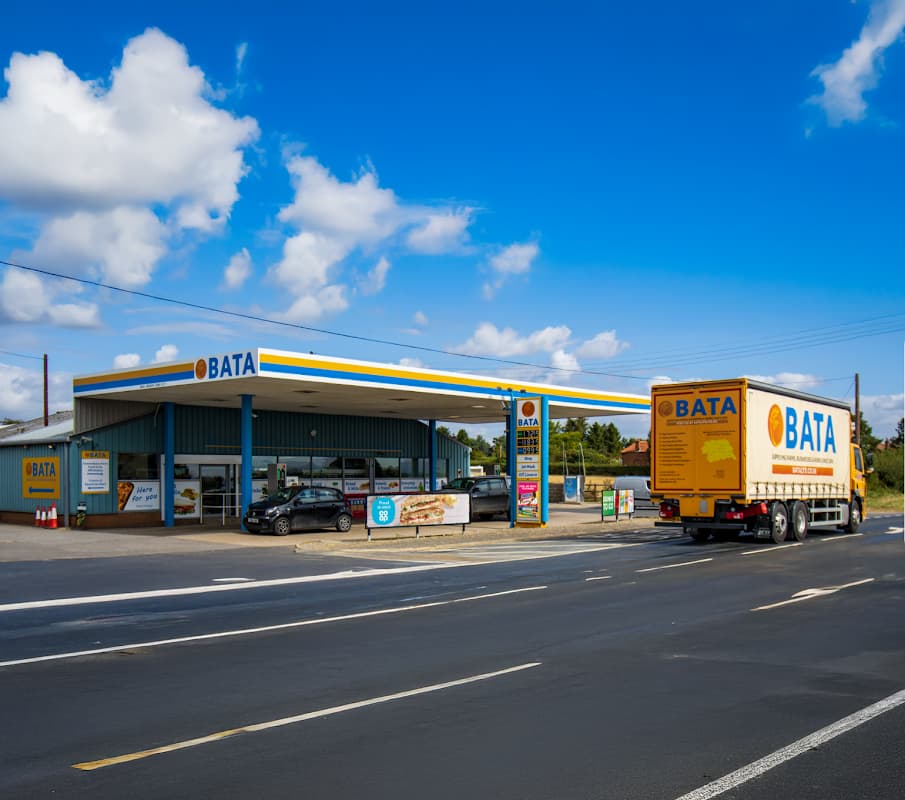 BATA petrol station with convenience store, featuring a truck and cars, set against a blue sky in Gate Helmsley.