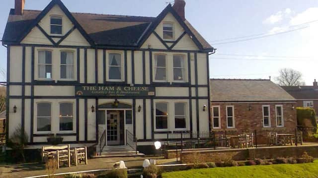 Victorian-style restaurant with black and white facade, large windows, and outdoor seating in Scagglethorpe, Yorkshire.