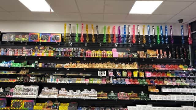 Colorful vape products and accessories displayed on shelves at SMOKE & VAPE Wombwell in Yorkshire.