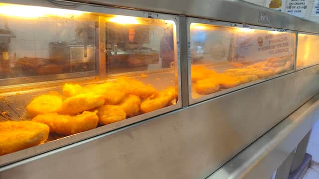 Fried food displayed in a heated glass cabinet at The Admiral 2 in Mosborough, Yorkshire.