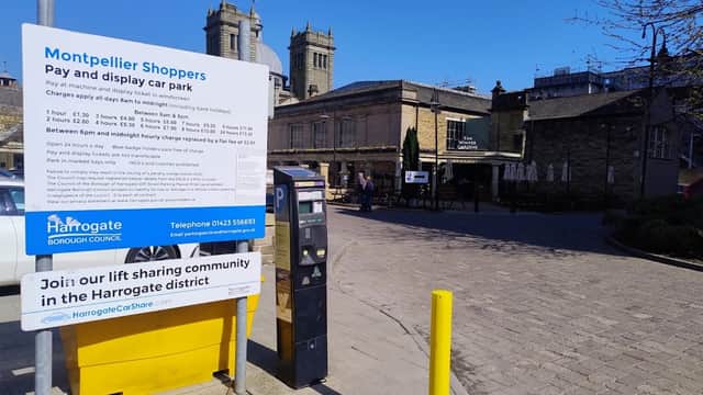 Montpellier Shoppers Pay & Display car park sign, ticket machine, and nearby buildings in Harrogate, Yorkshire.