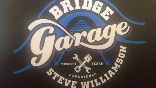 Logo for Bridge Garage featuring the text "Twenty Years Experience" and a wrench icon, with a blue and white design.
