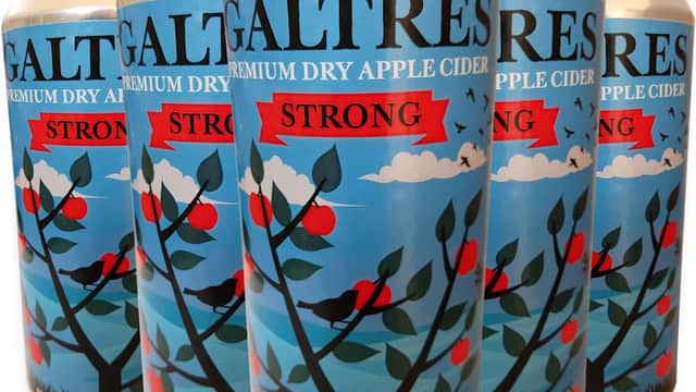 Cans of Galtres Premium Dry Apple Cider with vibrant tree and apple graphics, labeled "Strong" against a blue sky.