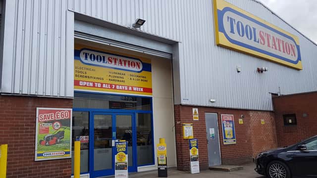 Brightly colored storefront of Toolstation in Sheffield, featuring signage for tools and homeware, with a car parked outside.