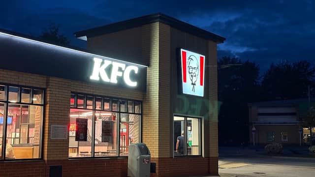 KFC restaurant exterior at night, featuring illuminated signage and a drive-thru area in Utley, Yorkshire.