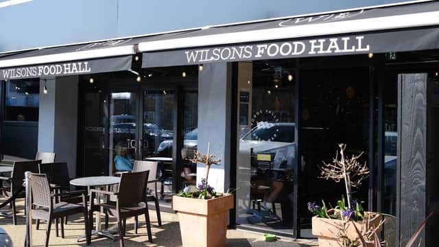 Exterior view of Wilsons Food Hall featuring outdoor seating, planters, and a modern storefront in Seamer, Scarborough.