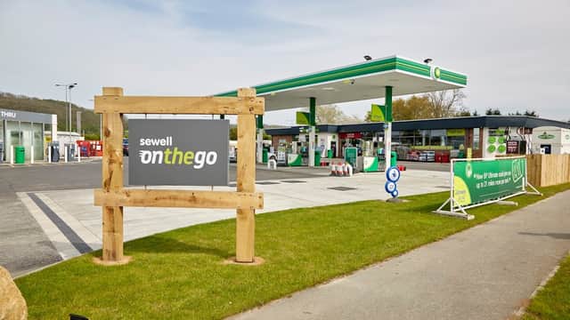 Sewell on the go sign in front of a petrol station with fuel pumps and green canopies in South Cave, Yorkshire.
