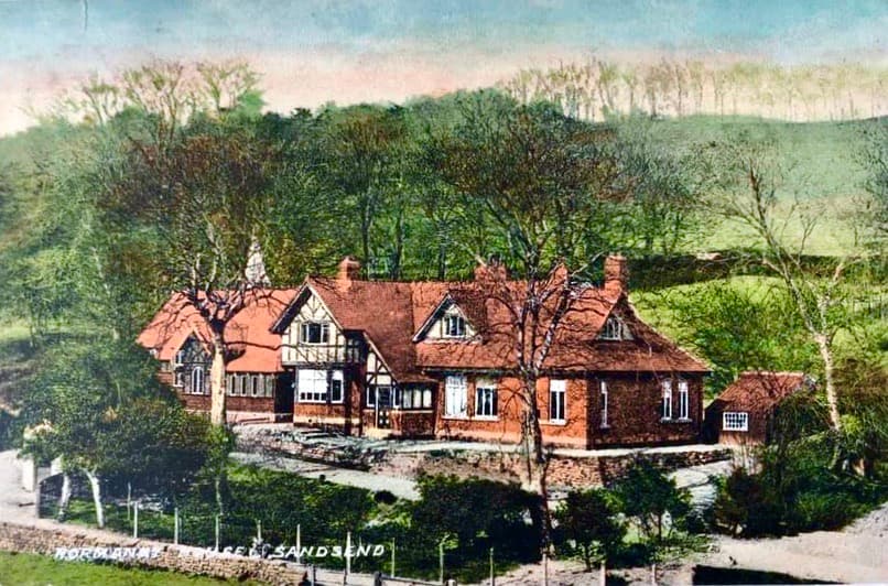 A charming guest house with red brick exterior, surrounded by lush greenery and trees in North Yorkshire.