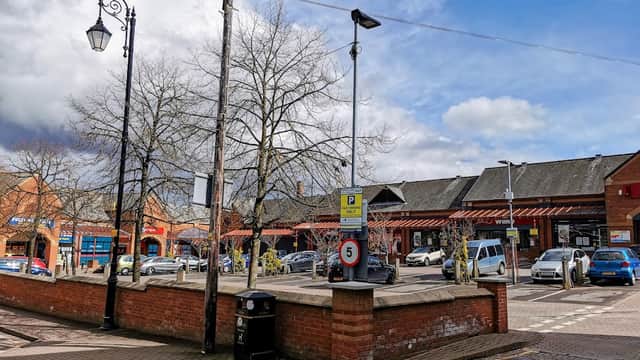 Market Square Car Park in Tingley, featuring pay & display signage, parked cars, and surrounding trees under a cloudy sky.
