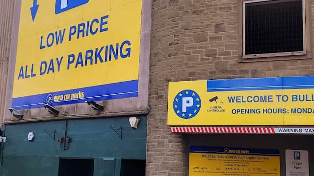 Bright yellow signage for Euro Car Parks, featuring parking symbols, opening hours, and a low price message.