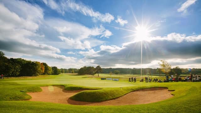 Sunny golf course at Rockliffe Hall, featuring sand traps and lush green fairways under a bright sky.