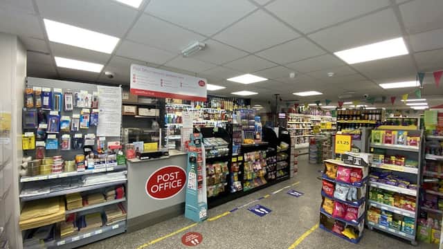 Bright cafe interior with shelves of snacks, drinks, and a prominent Post Office counter in South Cave, Yorkshire.