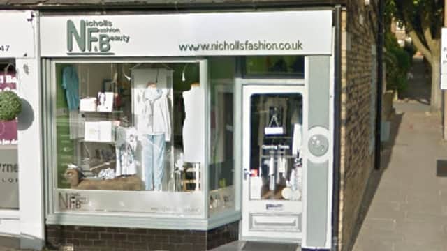 Storefront of Nicholls Fashion and Beauty featuring clothing displays and a welcoming entrance in Exley, Yorkshire.