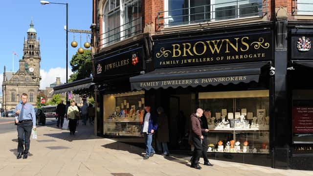 Browns Family Jewellers storefront in Sheffield, featuring a display of jewelry and pedestrians on the sidewalk.