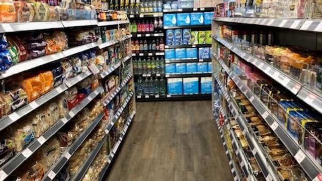 Aisle in SPAR grocery store with shelves of bread, cakes, and various household products in Gilberdyke, Yorkshire.