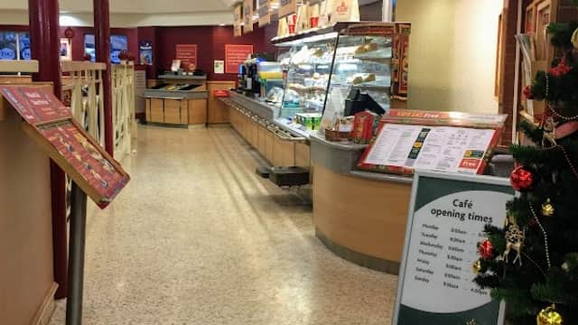 Interior of Morrisons featuring a café area, hot food counter, and festive decorations.